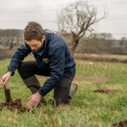 Andy planting tree at new woodland site